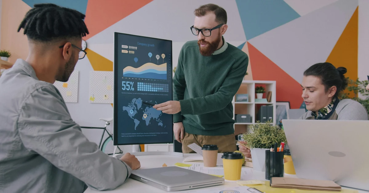 Presenting marketplace growth data to the team on a monitor